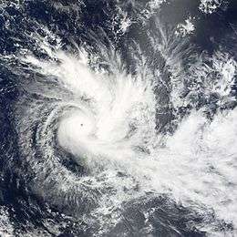 A tropical cyclone within the Fijian Islands. The cyclone has a clear and well defined eye with tight bands of clouds spiraling out from the eye.