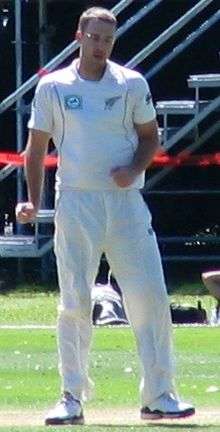 An cricketer from New Zealand wearing white Test cricket outfit.