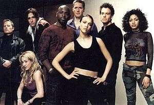 Eight reoccurring characters from the series first season posing for a promotional photograph