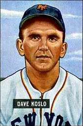 A baseball-card image of a man in a white baseball jersey with "NEW YORK" (obscured) on the chest and a blue baseball cap with an interlocking orange "NY" on the front
