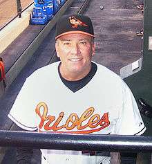 Dave Trembley in his Orioles uniform behind the dugout railing