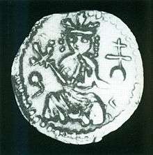 A shabby silver coin depicting a crowned figure