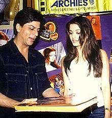 Shah Rukh Khan views a book with Aishwarya Rai in 2002