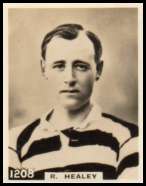 Photo card, numbered 1208 and captioned R. Healey, showing head and shoulders of a slightly balding man wearing a hooped shirt