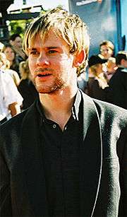 A picture of Dominic Monaghan. In the picture he is about 26 years old. He is white with blonde hair and a stubble.