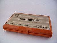 A closed, orange dual-screen handheld device with "Donkey Kong" written across the top.