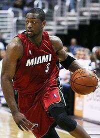 MDwyane Wade is driving to the basketball in an NBA game for the Miami Heat.