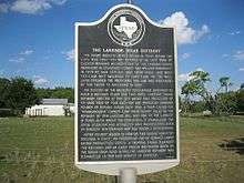 Photo shows a Texas state historical marker labeled The Lakeside Sugar Refinery.
