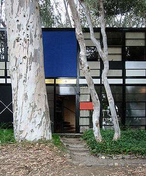 The front door and trees of the Eames House