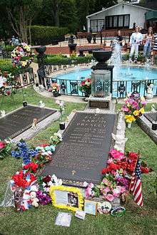 Photograph of Elvis Presley's grave at Graceland, with flowers.
