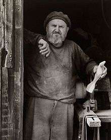 Photo of Emil Milan at his barn workshop c. 1980