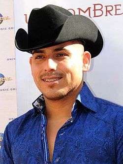 A man with a black cowboy hat on