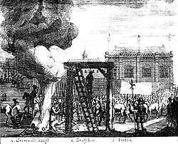 A gallows is in the centre of the image, to its left a large bonfire; a crowd watch.
