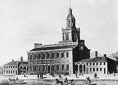 Drawing of a handsome building with a bell tower and a wing on each side. Horse-drawn carriages are seen in the street.