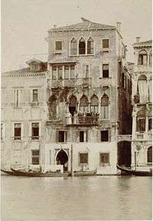 Victorian photograph of a Venetian palazzo with a group of people on the main balcony