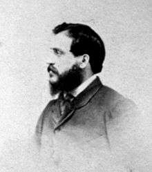 A head-and-shoulders photograph of Felice Beato in profile. He is facing towards the left of the frame and has a full beard.
