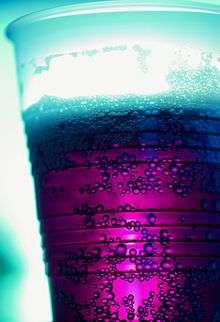 A cup of purple-colored soda