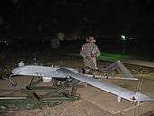 Sgt. Neal Naputo, a native of Zambales, Philippines, prepares to launch an unmanned aerial vehicle at Camp Taji, northwest of Iraq, 15 November.