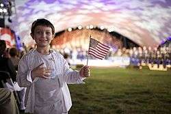 A boy holding an American flag during the 2009 National Memorial Day Concert