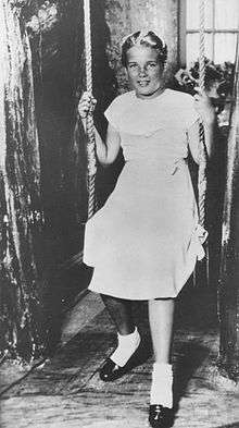 Studio portrait of Florence Sally Horner sitting on a swing.