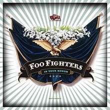 Against a background with white and green stripes lies a crest with banners, flowers and an eagle. Below the eagle is the title "Foo Fighters – In Your Honor" and four stars. Above the crest is a buffalo.