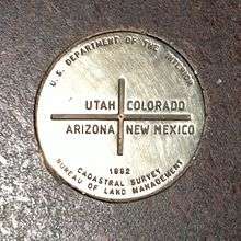 A metal disk reading "U.S. Department of the Interior – Utah, Colorado, Arizona, New Mexico – 1992 – Cadastral Survey – Bureau of Land Management"