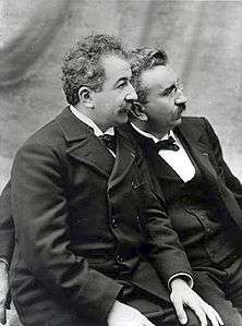 Auguste and Louis Lumière brothers seated looking left