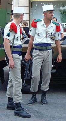Photograph of two members of the French Foreign Legion dressed in their traditional uniforms.