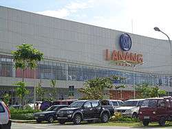 Front of large store, with cars in foreground