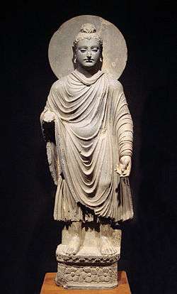 standing Buddha statue with draped garmet and halo