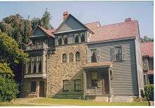 A large three-story house of wood and stone