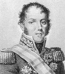 Klein has light curly hair and a round face; he wears heavy epaulets on the shoulders of an ornately embroidered jacket, decorated with military medals.