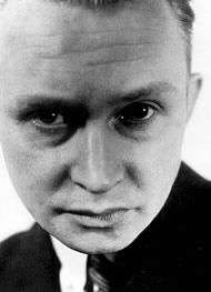 A tight black and white head shot of German artist Georg Muche