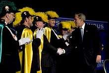 A photograph of President George Bush shaking hands with fourth degree knights.