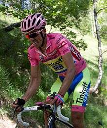 Alberto Contador climbing while wearing the pink leader's jersey