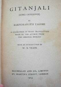 Close-up of yellowed title page in an old book: "Gitanjali (Song Offerings) by Rabindranath Tagore. A collection of prose translations made by the author from the original Bengali with an introduction by W. B. Yeats. Macmillan and Co., Limited, St. Martin's Street, London, 1913."