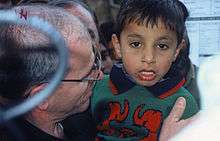 Bob Giuda in Kashmir with Pakistani child orphaned after major earthquake in 2005.