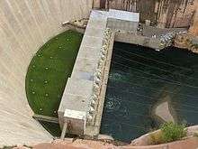 Top view of the Glen Canyon power plant. The dam is to the left, with a grassy lawn between the structures.