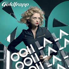 CD cover with a blond-haired woman at the centre standing with her hands on her hips and looking off to the right of the image. Text overlays the woman and the bottom right of the image saying "Ooh La La" three times. Text in the upper left corner says "Goldfrapp" along with a small text box stating "Ooh La La Including Exclusive New BSide". In the background is a black wall along with two teal-colored circles with triangle-shaped holes cut out of them.
