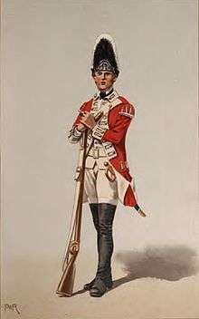 Print shows a standing soldier in a red coat with black gaiters and white breeches, turnbacks, and waistcoat. This soldier holds a musket and wears a tall bearskin hat.