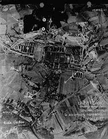 Aerial reconnaissance picture showing the Gusen I and II camps, marked with numbers and arrows pointing to some of the objects.
