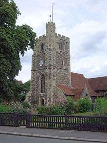 A tower similar to the one in the article infobox, with lighter stone, more quoining, different window designs and its turret on a different corner