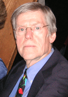 A photograph of a Caucasian senior wearing glasses.