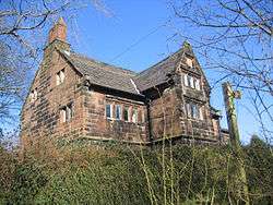 A sandstone house with gables