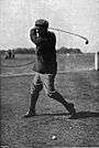 Photographic portrait of Harold Hilton swinging a golf club.