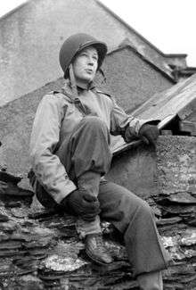 Picture of Helen Kirkpatrick in US Army combat uniform and wearing a steel helmet.  Picture taken in February 1944 by Ernie Marquardt of the US Army Pictorial Service