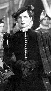 Hepburn dressed in medieval clothes, standing with a concerned look on her face.