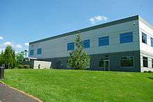 The Hillsboro School District's are headquartered in a two story concrete office building. The top level is white in color, the lower level gray.