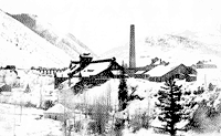 A black-and-white photograph of an industrial facility with a tall smokestack on a snow-covered riverbank
