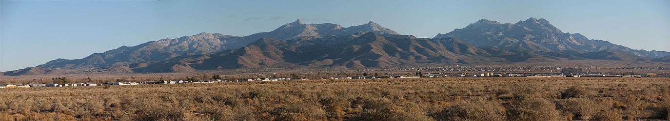 A panorama of the Hualapai Mountain range seen from Kingman, Arizona. The photographs were taken in late December and the mountains have a light dusting of snow. The camera location was south of Northern Avenue, east of Bank Street.